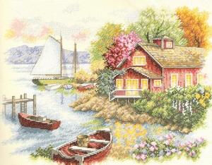 Huis met zeilboot aan het meer